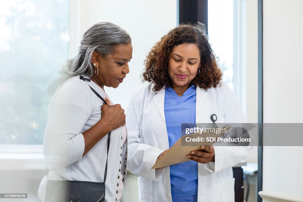 Doctor consulting with mature patient